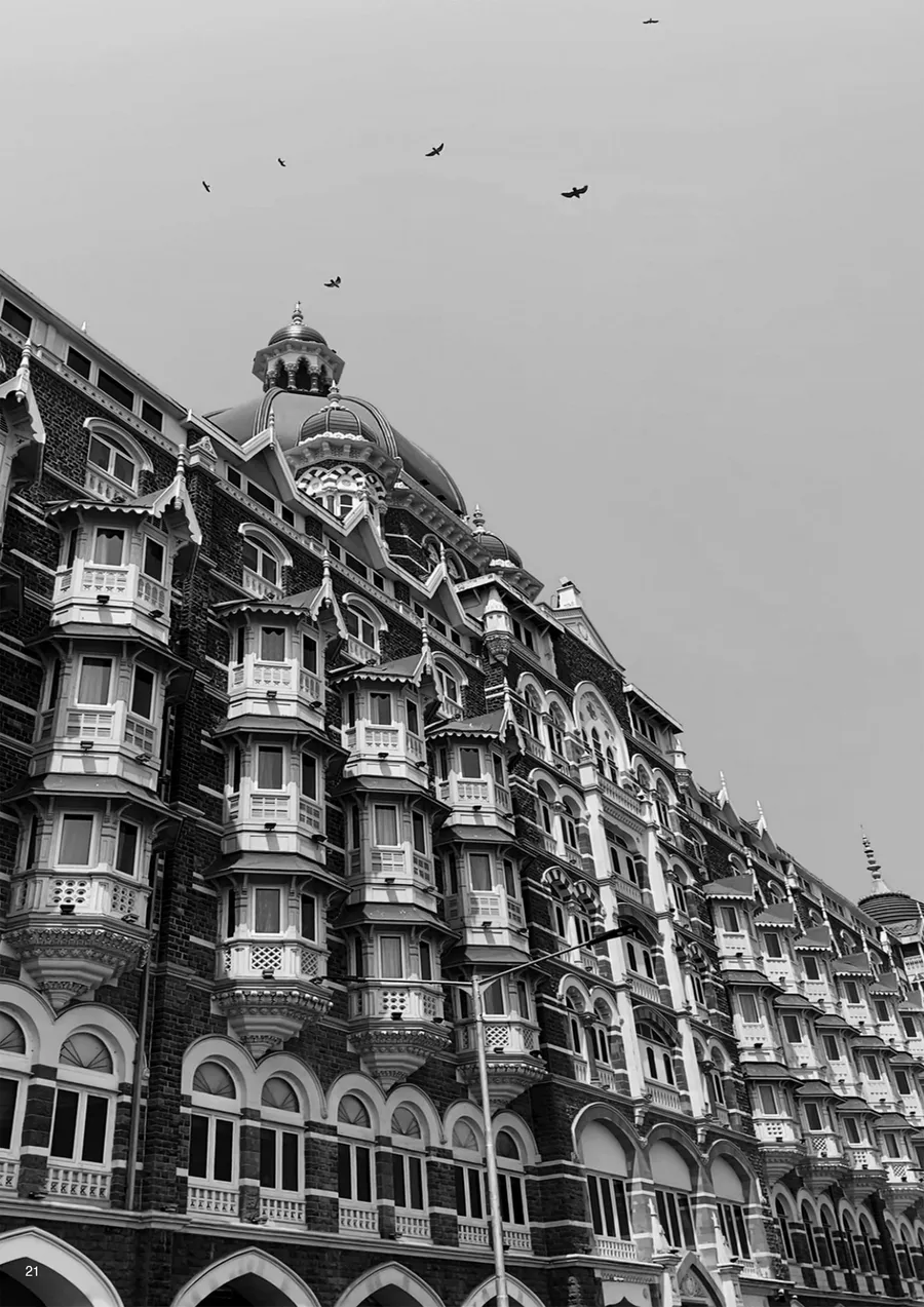 Black-and-white photograph of an ornate Indo-Saracenic hotel facade with bay windows and a dome.